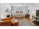 Open living space featuring a decorative fireplace, hardwood floors, and ceiling fan at 171 Queen St, Charleston, SC 29401