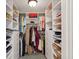 Well-organized walk-in closet with built-in shelving and ample storage space for clothes and accessories at 171 Queen St, Charleston, SC 29401