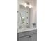 Clean and modern bathroom with a decorative mirror, ample lighting, and a stylish gray vanity at 1894 Brittlebush Ln, Johns Island, SC 29455