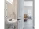 Bathroom with a mirror, toilet, sink and doorway leading into a garage with a bike in the distance at 1894 Brittlebush Ln, Johns Island, SC 29455