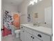 Well-lit bathroom features a double vanity, a shower with curtain and neutral decor at 1894 Brittlebush Ln, Johns Island, SC 29455