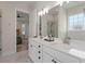 Bathroom features a double vanity with white countertops and a view to the bedroom at 1894 Brittlebush Ln, Johns Island, SC 29455