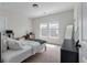 Cozy bedroom featuring neutral walls, two windows, and a comfortable bed with stylish bedding for a serene retreat at 1894 Brittlebush Ln, Johns Island, SC 29455