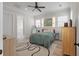 Bright bedroom with a ceiling fan, a map, and a door to the bathroom at 1894 Brittlebush Ln, Johns Island, SC 29455