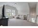 Bright bonus room features a sofa and large windows for ample natural light at 1894 Brittlebush Ln, Johns Island, SC 29455
