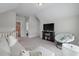 Bonus room features a television, sofa and access to a bathroom at 1894 Brittlebush Ln, Johns Island, SC 29455