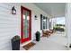 Cozy front porch featuring stylish seating, a welcoming doormat, and decorative potted plants at 1894 Brittlebush Ln, Johns Island, SC 29455