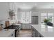 Spacious kitchen with white cabinets, stainless-steel appliances and a gray island at 1894 Brittlebush Ln, Johns Island, SC 29455