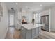 Bright kitchen showcases white cabinetry, stainless-steel appliances, and a gray kitchen island at 1894 Brittlebush Ln, Johns Island, SC 29455
