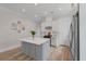 Bright kitchen features a gray island with white countertop and stainless-steel appliances at 1894 Brittlebush Ln, Johns Island, SC 29455
