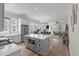 Open concept kitchen features a gray island with built-in microwave, connecting to the living room at 1894 Brittlebush Ln, Johns Island, SC 29455