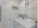 Functional laundry room with white washer, dryer, storage cabinets, and clean finishes for convenience at 1894 Brittlebush Ln, Johns Island, SC 29455