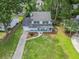 Aerial view of a two-story home with an attached garage and a beautifully landscaped front yard at 2020 Piper Dr, Charleston, SC 29407