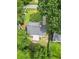 A bird's eye view of a well-maintained roof, lush yard, and surrounding greenery near a quiet neighborhood street at 2020 Piper Dr, Charleston, SC 29407