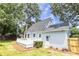 This light blue home has a white deck and an entrance door, surrounded by lush greenery and a well-kept lawn at 2020 Piper Dr, Charleston, SC 29407