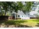 A charming light blue home features a spacious backyard with a white deck and lush green lawn at 2020 Piper Dr, Charleston, SC 29407