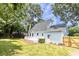 An exterior shot of a light blue home featuring a white deck and a well-maintained lawn at 2020 Piper Dr, Charleston, SC 29407