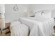 Bedroom featuring a plush white bed with throw blankets, side table, cowhide rug and view to bathroom at 2020 Piper Dr, Charleston, SC 29407