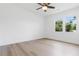 This bright bedroom features laminate flooring and a ceiling fan at 2020 Piper Dr, Charleston, SC 29407