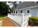 A close-up view of a white deck with views of a light blue home at 2020 Piper Dr, Charleston, SC 29407