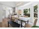 Bright dining area with a modern light fixture, large windows, and an open floor plan to the kitchen at 2020 Piper Dr, Charleston, SC 29407