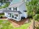 Well-maintained home with a covered porch, complete with charming rocking chairs, and lush green landscaping at 2020 Piper Dr, Charleston, SC 29407