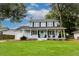 Charming two-story home with a covered front porch, lush lawn, and traditional architectural details at 2020 Piper Dr, Charleston, SC 29407