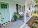 Charming front porch with rocking chairs, potted plants, and a welcoming entrance at 2020 Piper Dr, Charleston, SC 29407