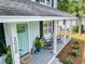 Inviting front porch featuring rocking chairs, stylish decor, and a charming entrance at 2020 Piper Dr, Charleston, SC 29407