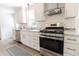 Modern kitchen featuring stainless steel appliances, white cabinets, granite countertops, and a subway tile backsplash at 2020 Piper Dr, Charleston, SC 29407