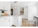 Stylish kitchen featuring white cabinets, granite countertops, and stainless steel appliances at 2020 Piper Dr, Charleston, SC 29407