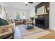 Bright living room with a black fireplace, plush seating, and a large window at 2020 Piper Dr, Charleston, SC 29407