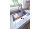 Close up of a stainless steel sink with granite countertops and subway tile backsplash at 2020 Piper Dr, Charleston, SC 29407
