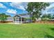 Expansive backyard with green lawn, a screened-in porch, and mature trees at 2024 Lanneau Ln, Johns Island, SC 29455