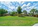 Lush backyard with a well-maintained lawn, mature trees, and a wooden fence at 2024 Lanneau Ln, Johns Island, SC 29455