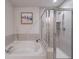 Beautiful bathroom featuring a luxurious soaking tub and separate glass-enclosed shower at 2024 Lanneau Ln, Johns Island, SC 29455
