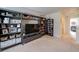 Bonus room with built-in bookshelves, TV area, and access to hallway and bedroom at 2024 Lanneau Ln, Johns Island, SC 29455