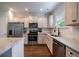 Modern kitchen featuring stainless steel appliances, a tile backsplash and white cabinets at 2024 Lanneau Ln, Johns Island, SC 29455