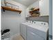 Functional laundry room with modern appliances, storage, and decorative shelving at 2024 Lanneau Ln, Johns Island, SC 29455