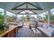 Inviting screened-in porch with comfortable seating, a hanging swing, and an outdoor dining area at 2024 Lanneau Ln, Johns Island, SC 29455