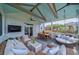 Relaxing screened porch featuring comfortable seating, a ceiling fan, and outdoor entertainment options at 2024 Lanneau Ln, Johns Island, SC 29455
