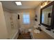 Bathroom featuring marble-look walls, framed mirror, and a shower-tub combo at 205 Indian Field Cir, Saint George, SC 29477