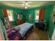 Green bedroom with natural light, hardwood floors, and traditional furnishings at 205 Indian Field Cir, Saint George, SC 29477