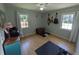 Bright bedroom with hardwood floors, two windows and guitars on the wall at 205 Indian Field Cir, Saint George, SC 29477