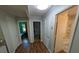 Hallway with wood floors and multiple doorways leading to bedrooms and a bathroom at 205 Indian Field Cir, Saint George, SC 29477