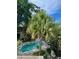 Overhead view of the private pool and backyard with lounge chairs and tropical trees at 2066 Wappoo Dr, Charleston, SC 29412