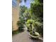 Picturesque backyard with stone fountain, gravel path, and greenery, creating a serene garden oasis at 2066 Wappoo Dr, Charleston, SC 29412
