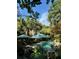 Secluded backyard with pool, patio furniture, lush landscaping, and palm trees at 2066 Wappoo Dr, Charleston, SC 29412