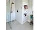 Modern bathroom with glass shower, white subway tile, niche, built-in shelving and classic penny tile flooring at 2066 Wappoo Dr, Charleston, SC 29412