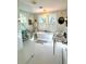 A bright bathroom with a soaking tub, double vanity, and white tile flooring at 2066 Wappoo Dr, Charleston, SC 29412